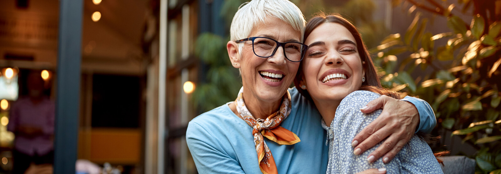 Two adult women embracing outside