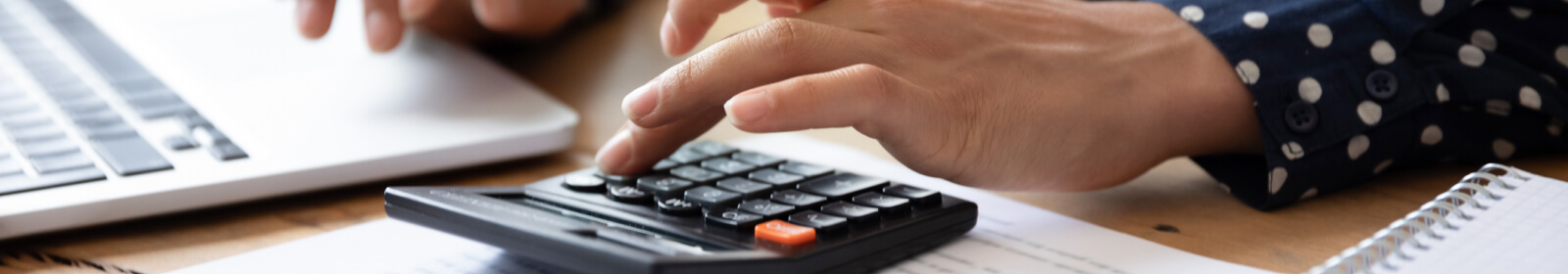 Close up of a person's hands using a calculator