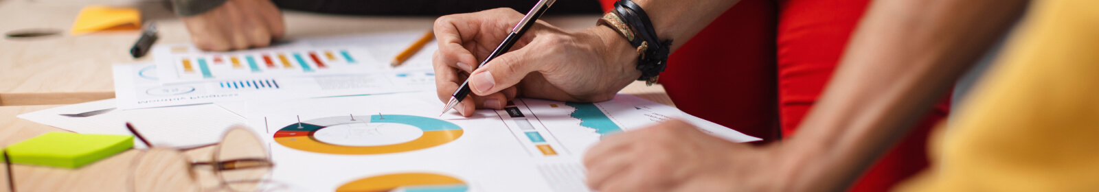 Close up of a person's hands writing on a document